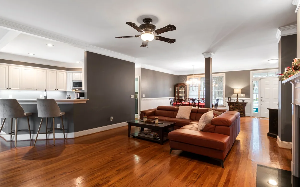 Ceiling fan installed above a living room with wood floors