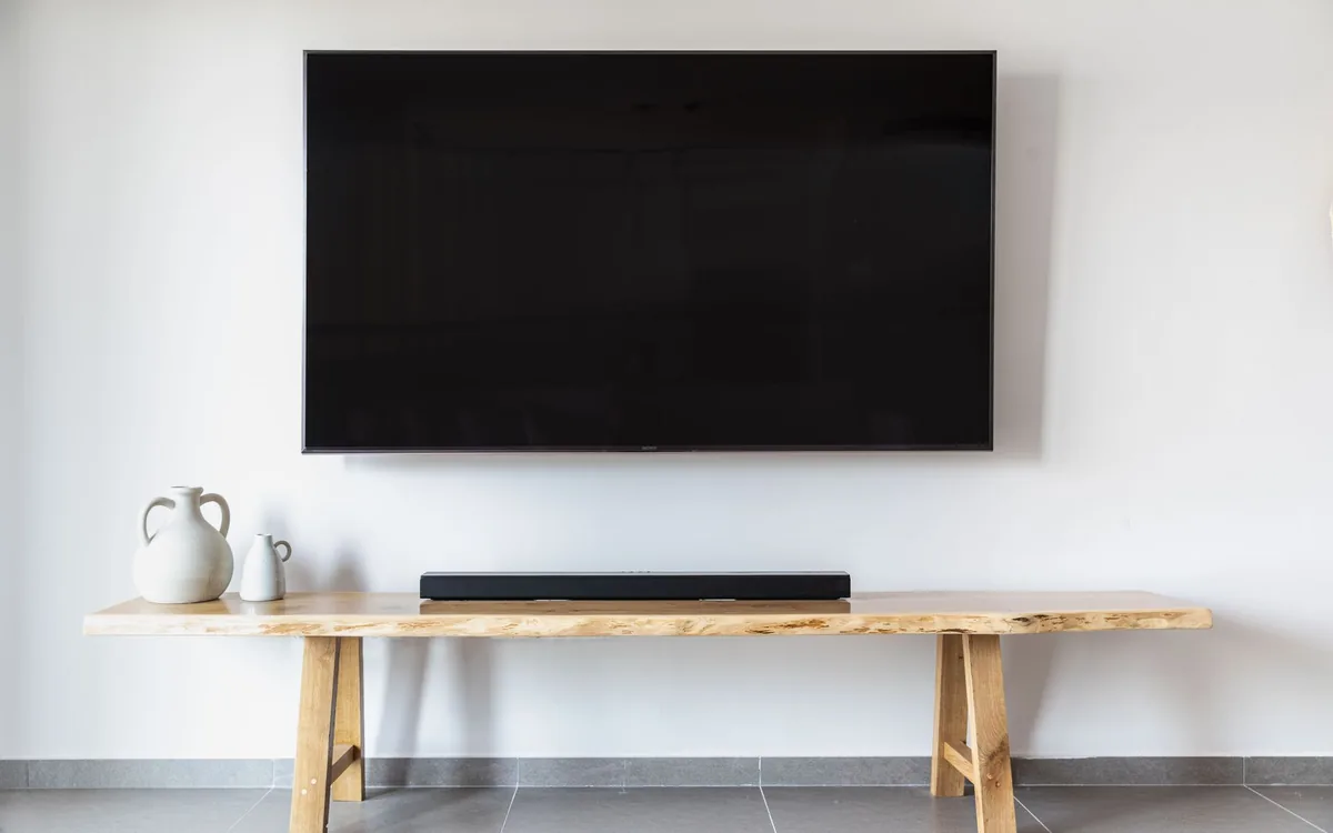 Flat screen TV mounted flush on a living room wall